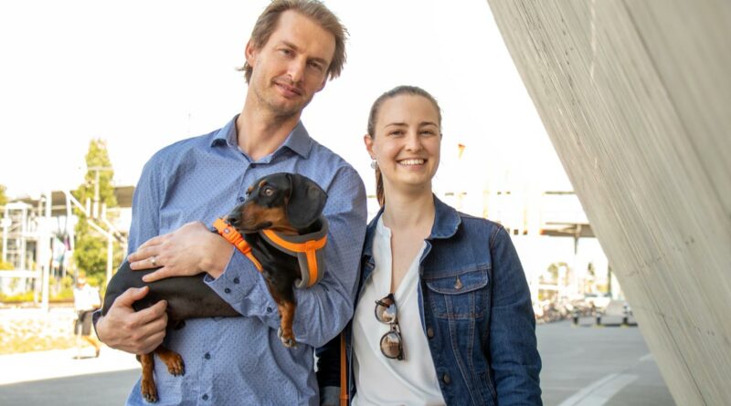 Melissa and Eon de Klerk carrying a dog