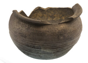 Mittelalterlicher Kugeltopf, ein rundlich bauchiges, fast vollständig erhaltenes Gefäß mit einem nach außen gewölbten sogenannten Linsenboden. 